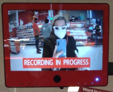 Person on screen in mask and glasses at Target checkout, labeled "recording in progress"