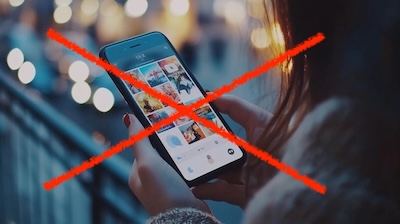Person scrolling social media feed with a red X across.